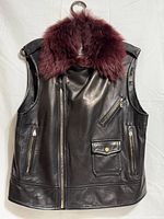 Front view of black leather vest with burgundy faux fur collar