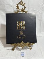 Front cover on ornate stand