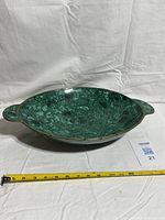 Top view of green malachite bowl with brass rim and handles