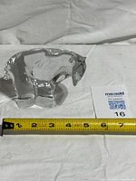 Side view of crystal polar bear with tape measure