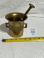 Mortar and pestle with measuring tape for scale