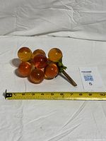 Full view of lucite grape cluster with measuring tape showing length