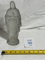 Full view of frosted glass Virgin Mary statue beside measuring tape showing height