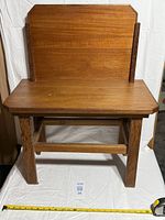 Front view of solid wood bench with backrest