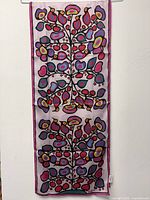 Full view of silk scarf hanging to show artwork and dimensions