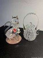 Cat and teapot figurines side by side