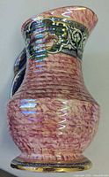 Left side view of pink lustreware Newhall pitcher showing floral band and handle
