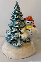 Front view of ceramic snowman and Christmas tree lamp