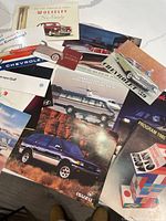 Overhead view showing majority of brochures fanned out, visible titles and artwork