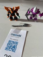 Both Battle Beasts figures with weapons laid out on surface