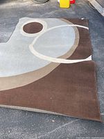 Full view of the rug showing abstract circular pattern and colour palette