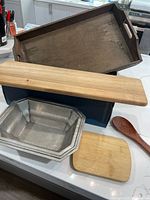 All five items arranged: charcuterie board, pewter bowl, wooden tray, small cutting board, wooden spoon