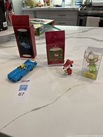 Overview of all three ornaments with their boxes on countertop