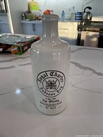 Full front view of stoneware whisky jug showing label