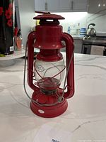 Front view of red Dietz kerosene lantern