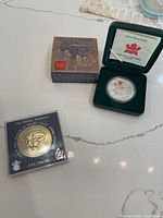 Both coins with packaging visible