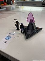 Full lot showing vehicle with both figures