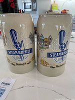 Front view of both Steam Whistle Oktoberfest steins showing logos