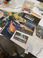 All brochures spread on tabletop showing covers and artwork