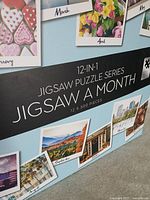 Front of box displaying 12-in-1 Jigsaw Puzzle Series branding and sample monthly images