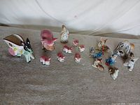 Full group of 16 ceramic figures on tabletop