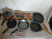 Group shot of five pans and boxed kebob rack
