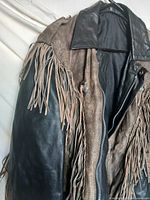 Front view of two-tone fringed leather jacket