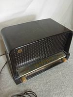 Front angled view of GE Musaphonic radio showing grille, dial, knobs