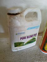 Close-up of Botanicare Pure Blend Pro jug showing brand and use wear