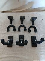 Six FretRest wall guitar hangers laid out, showing both square and rectangular bases