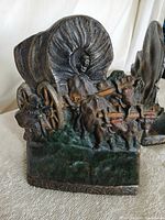 Close view of one bookend showing covered wagon, horses, driver and painted details