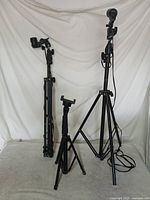 Three light stands and one tabletop tripod displayed