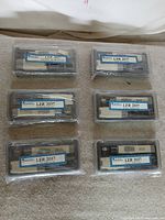 Six shrink-wrapped microscope sets in cases