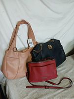 Three handbags displayed together