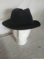 Front view of black Stetson Key Club fedora on display head