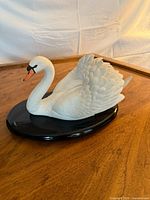 Full view of swan sculpture on base