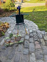 Group shot of all three metal garden figures on stone path