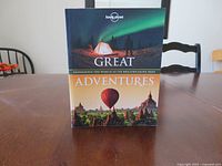 Front cover showing title, publisher logo, and cover images of tent under aurora and hot-air balloon over temples