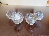 Four cut-glass ends of two knife rests showing starburst pattern