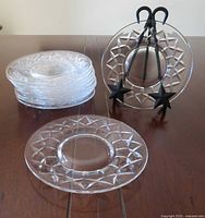 Stack of plates, one displayed on stand, shows starburst border and transparency