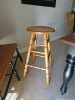 Full view of bar stool showing seat, legs, stretchers