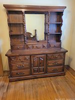 Full frontal view of dresser and hutch showing mirror, shelves, drawers, door
