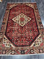 Full view of entire Hamadan rug showing design and wear