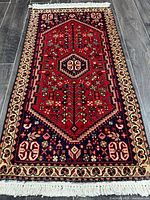 Full view of the Shiraz rug showing entire design and fringes
