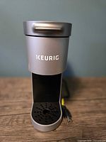 Front view of silver Keurig single-serve brewer