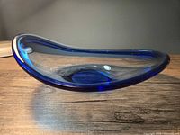 Side view showing irregular curved profile and blue gradient