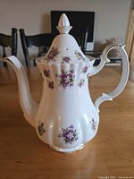 Front view of Royal Albert Sweet Violets coffee pot showing floral pattern and gold trim