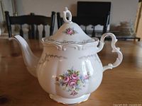 Left profile of Royal Albert Tranquility teapot showing floral pattern, handle detail, lid and spout