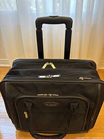 Front view showing Bugatti badge, zip compartments, carry handles