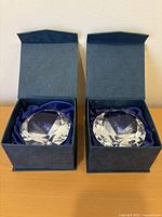 Both crystal diamond paperweights in open blue presentation boxes